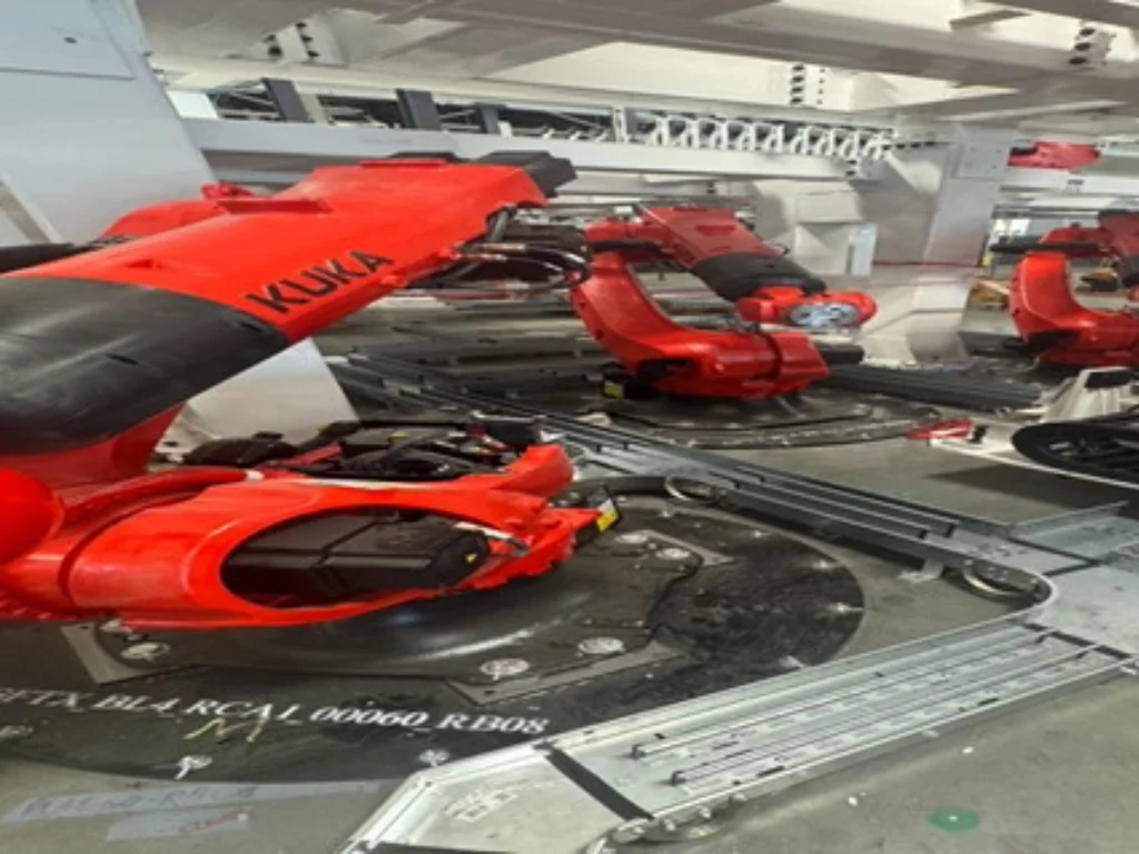 Industrial robot performing rear cargo assembly automation for Tesla W68 project