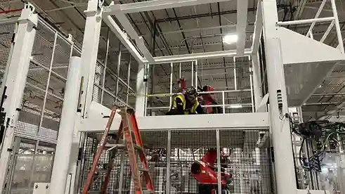 Supervisor overseeing industrial electrical work from upper platform
