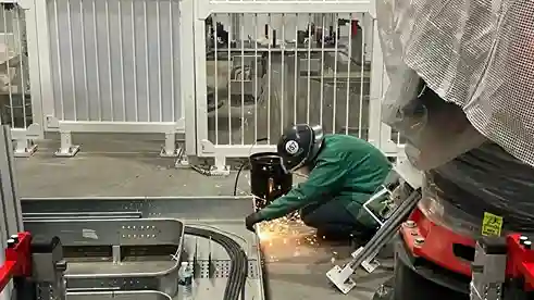 Electrical specialist soldering wiring during automation setup