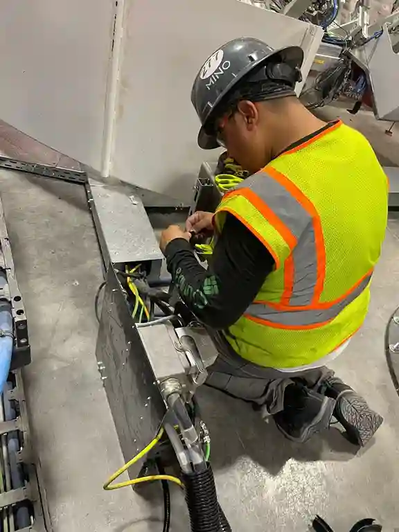 Engineer supervising cable routing and electrical installation